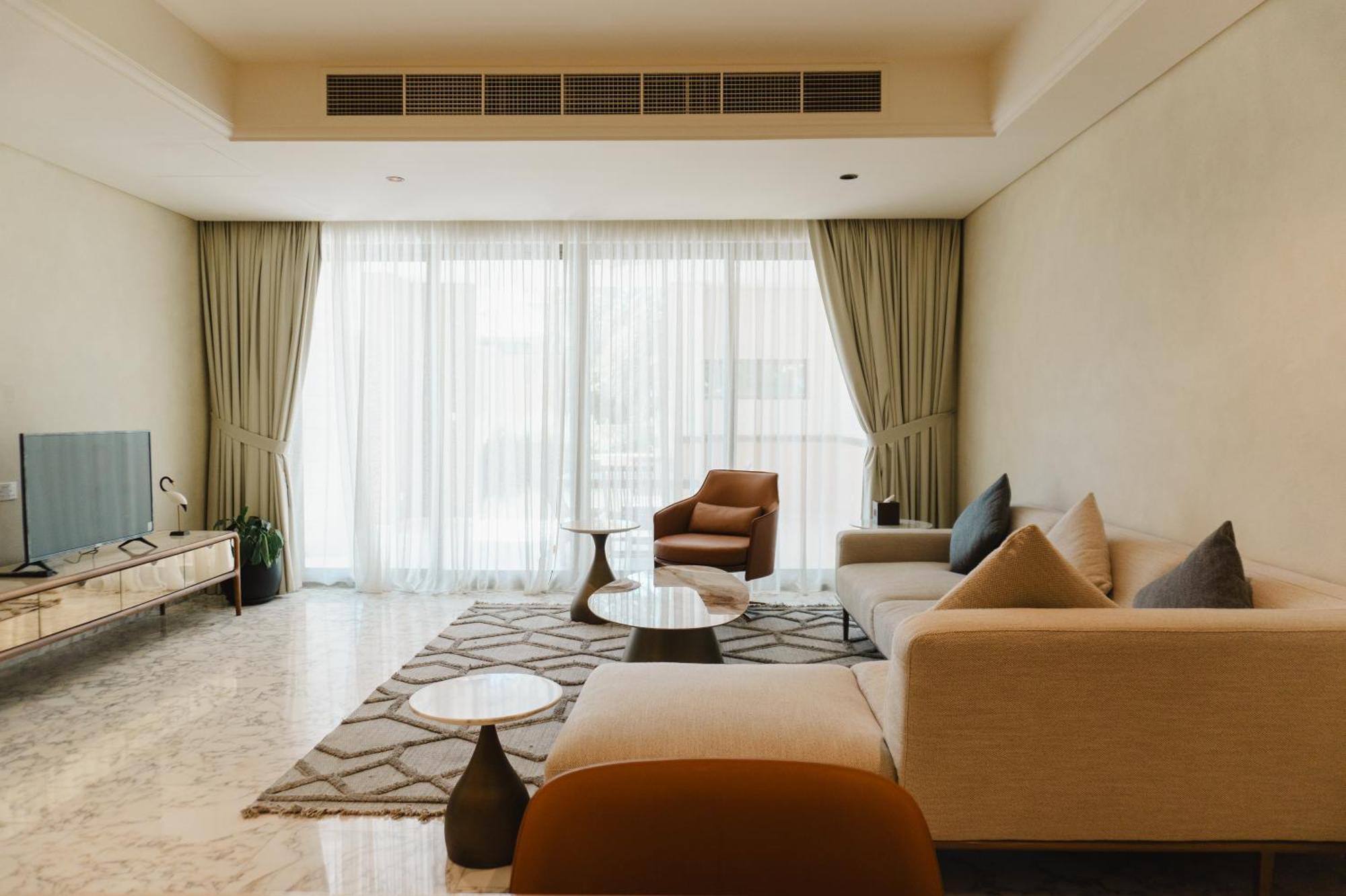 Palavra Resort Manama Exterior foto A living room in a condominium